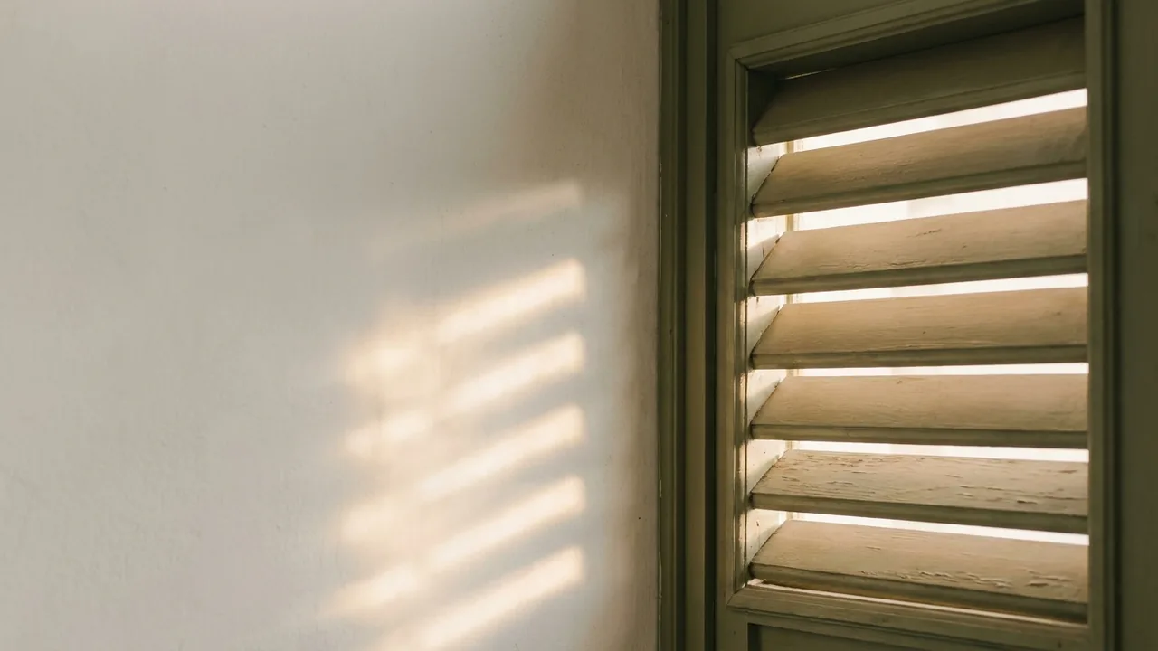 Afternoon light passing through timber shutters