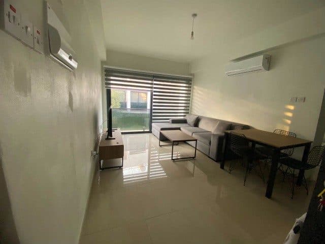 Gray corner sofa, dining table, and sliding glass door