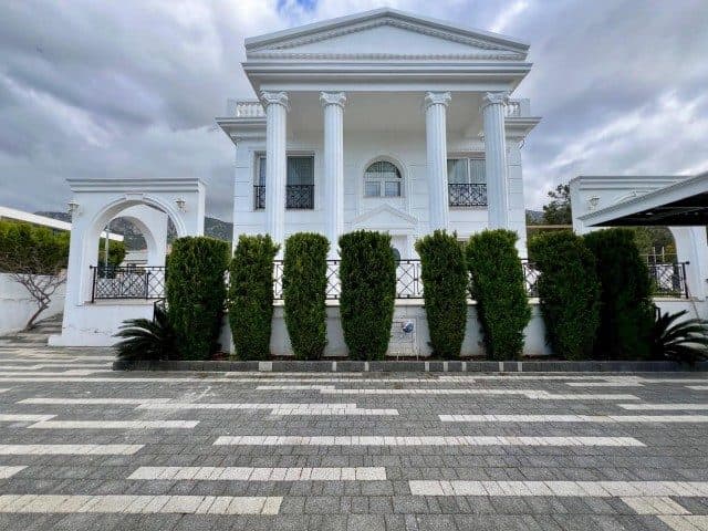White columned facade and a patterned stone entrance path