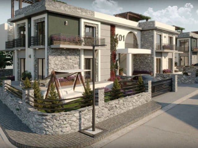 Taş duvarlı cephe, balkonlar ve çitli ön bahçe