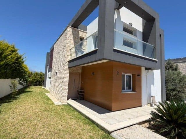 Taş kaplama duvar, üst balkon ve çim bahçe