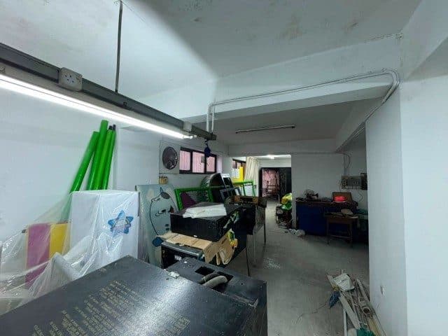 Flüoresan aydınlatmalı depoda makineler ve malzemeler görülüyor