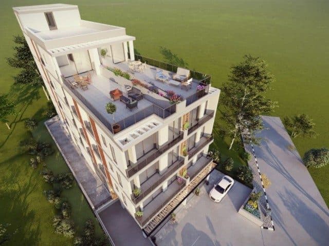 Üst terasta oturma grubu, önde balkonlar ve park alanı