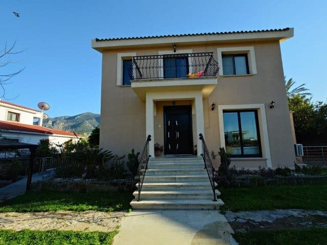 Entrance steps and the upper-floor balcony stand out on the facade.