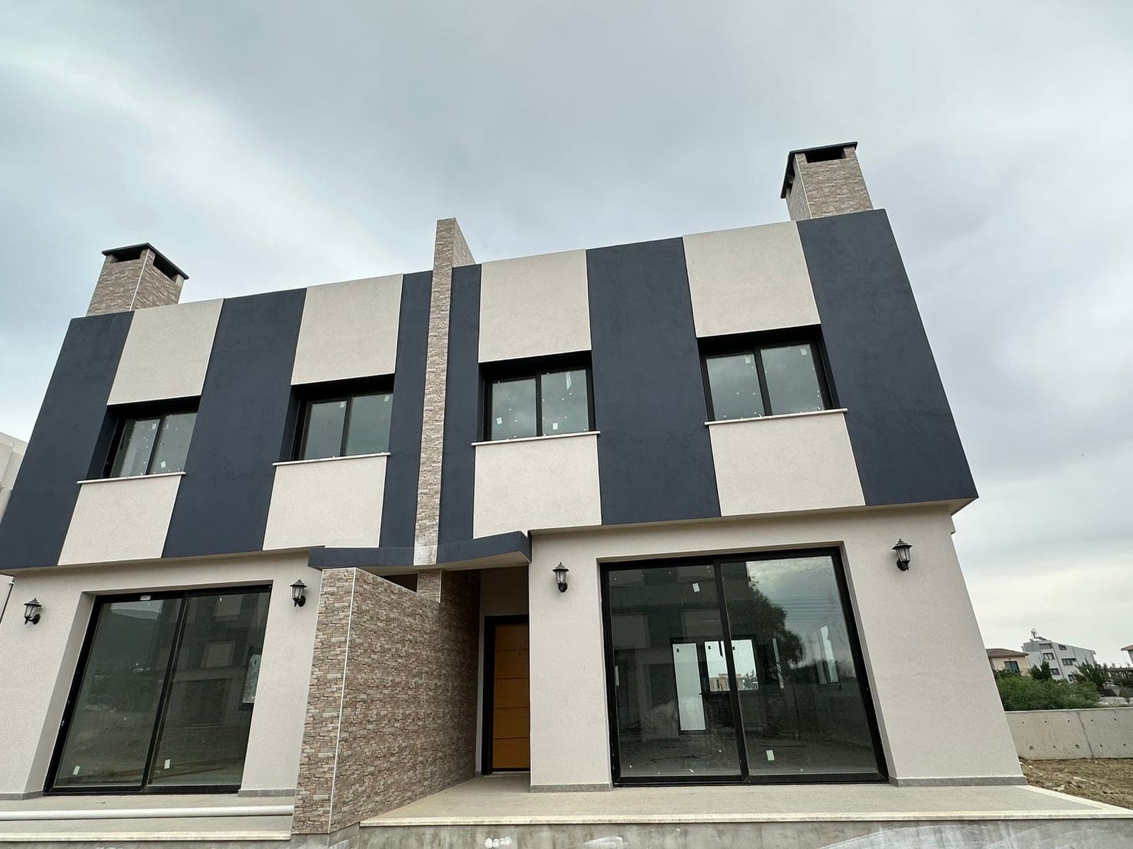 Exterior of a modern two-story villa in gray and white