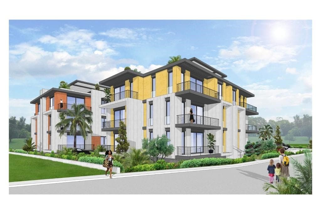 Front facade of a modern apartment building with landscaped garden.