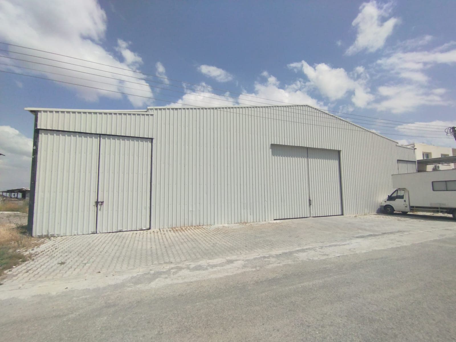 Metal-clad warehouse building with a spacious front area