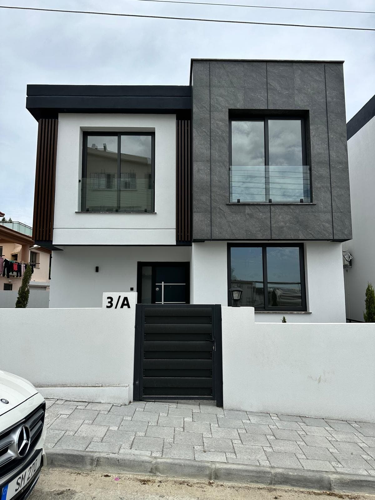 Modern villa exterior in white and grey tones