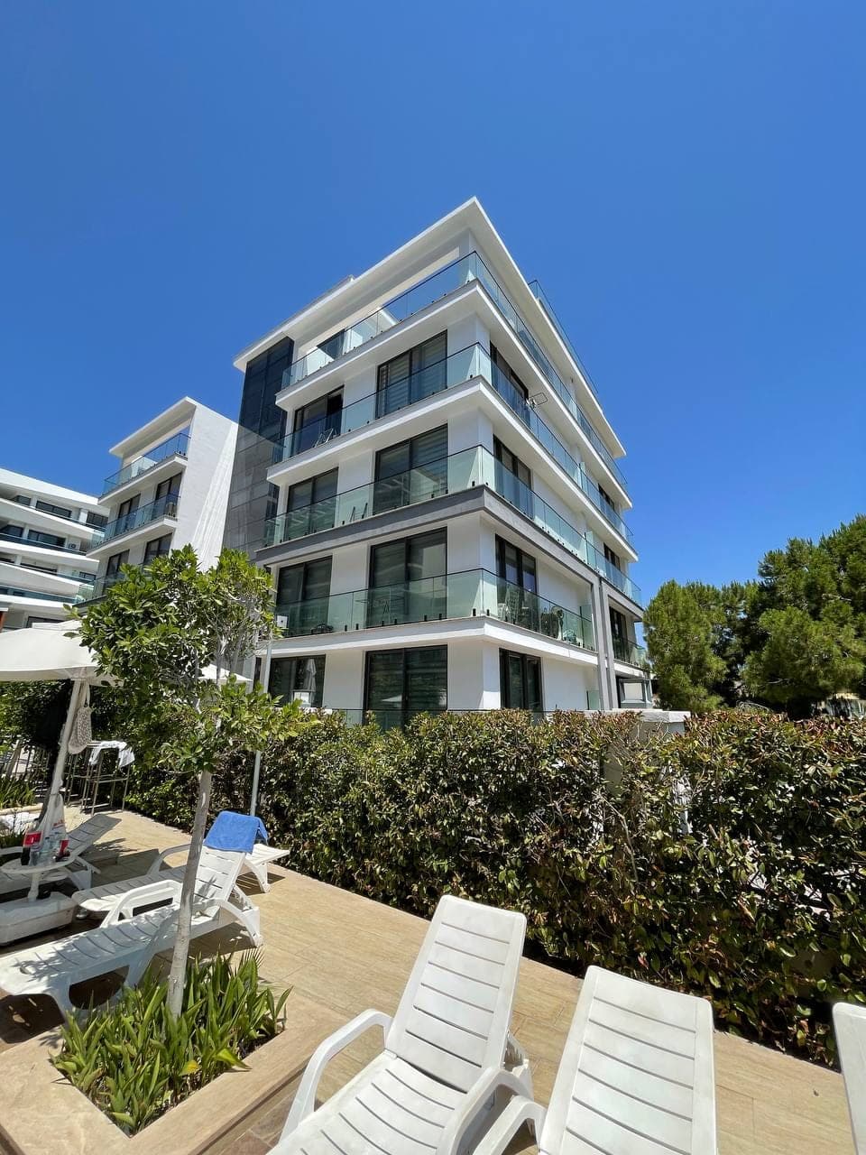 Modern white building with shared pool area