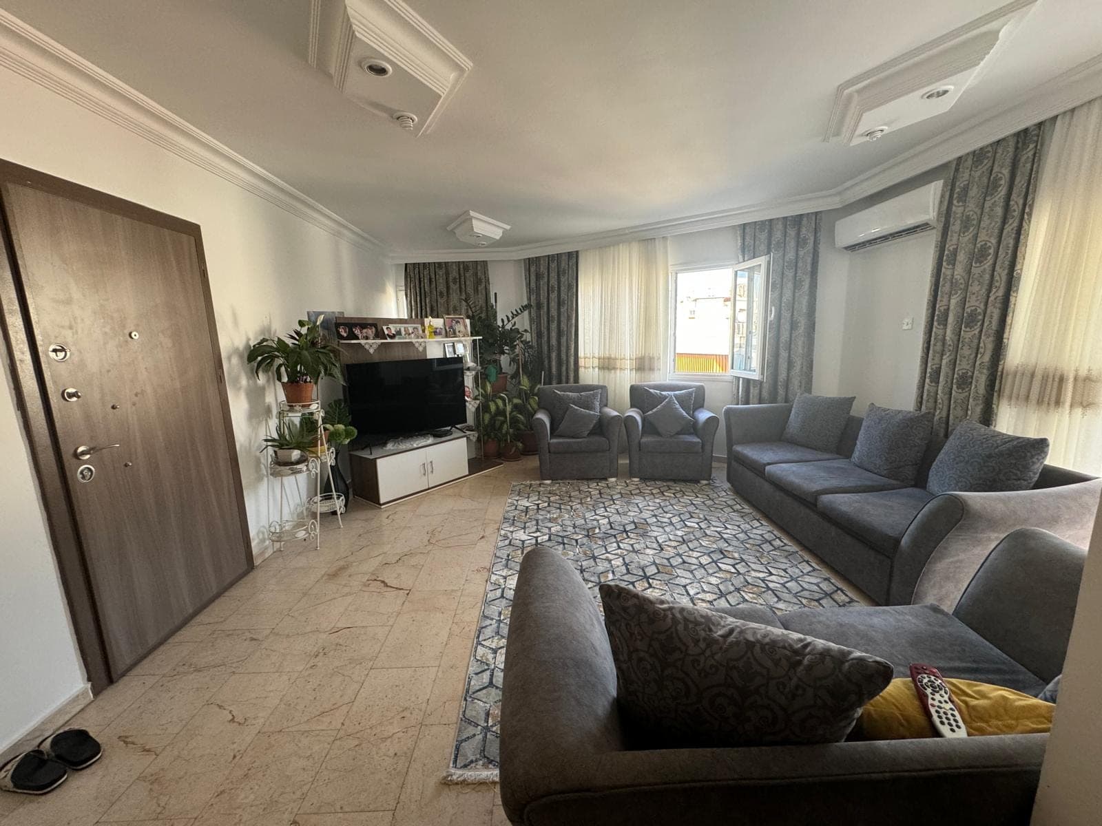 Spacious living room with TV unit and air conditioning