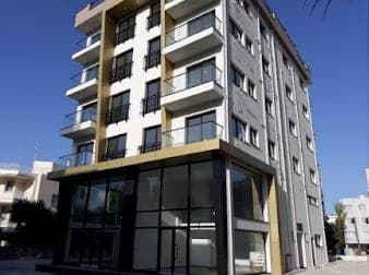 Exterior of a newly built multi-story building with modern architecture.