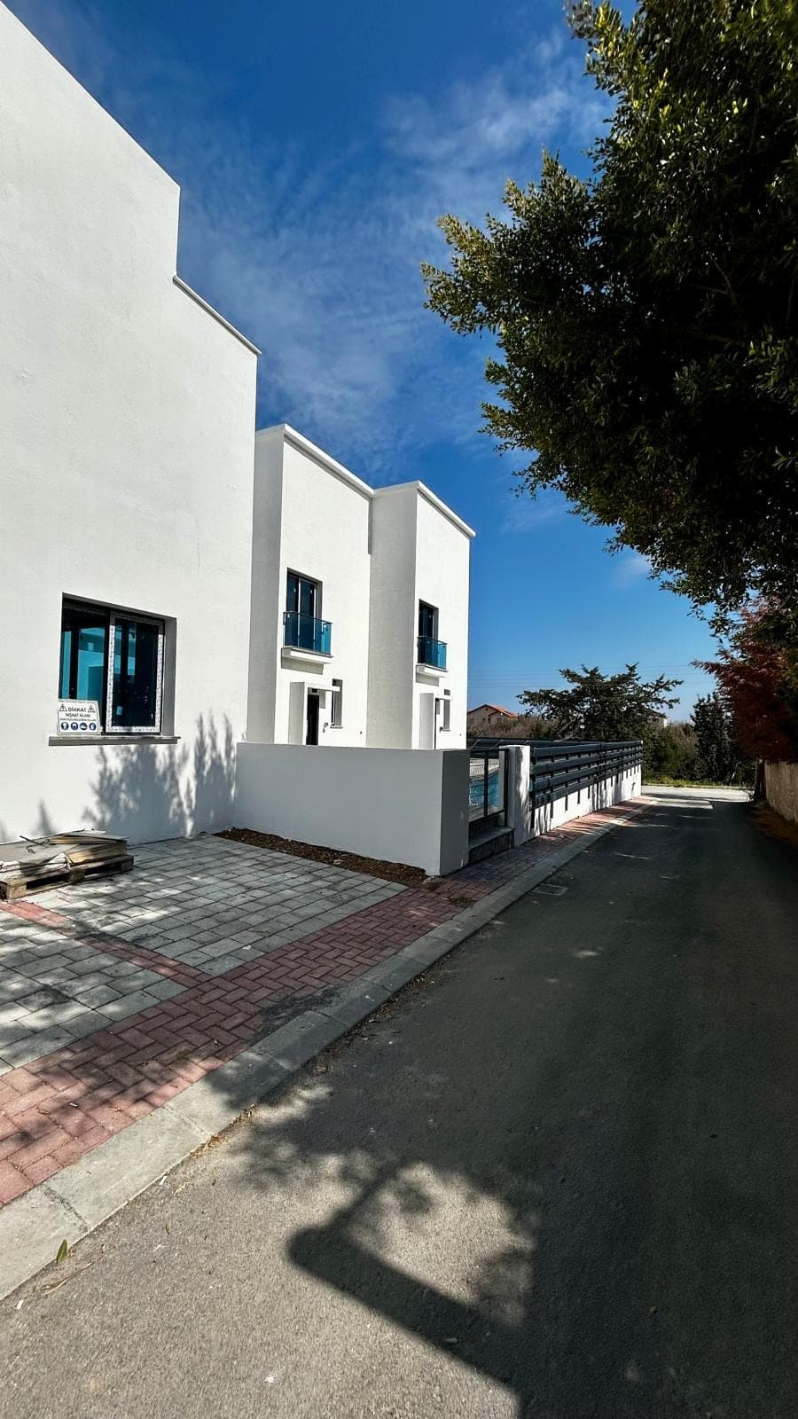 Exterior of a newly built villa with parking area