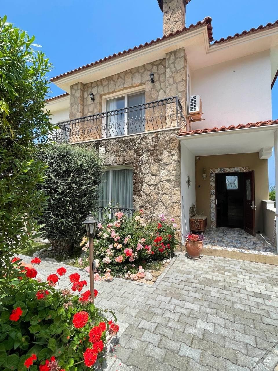 Stone detailed exterior, front garden and upper floor balcony