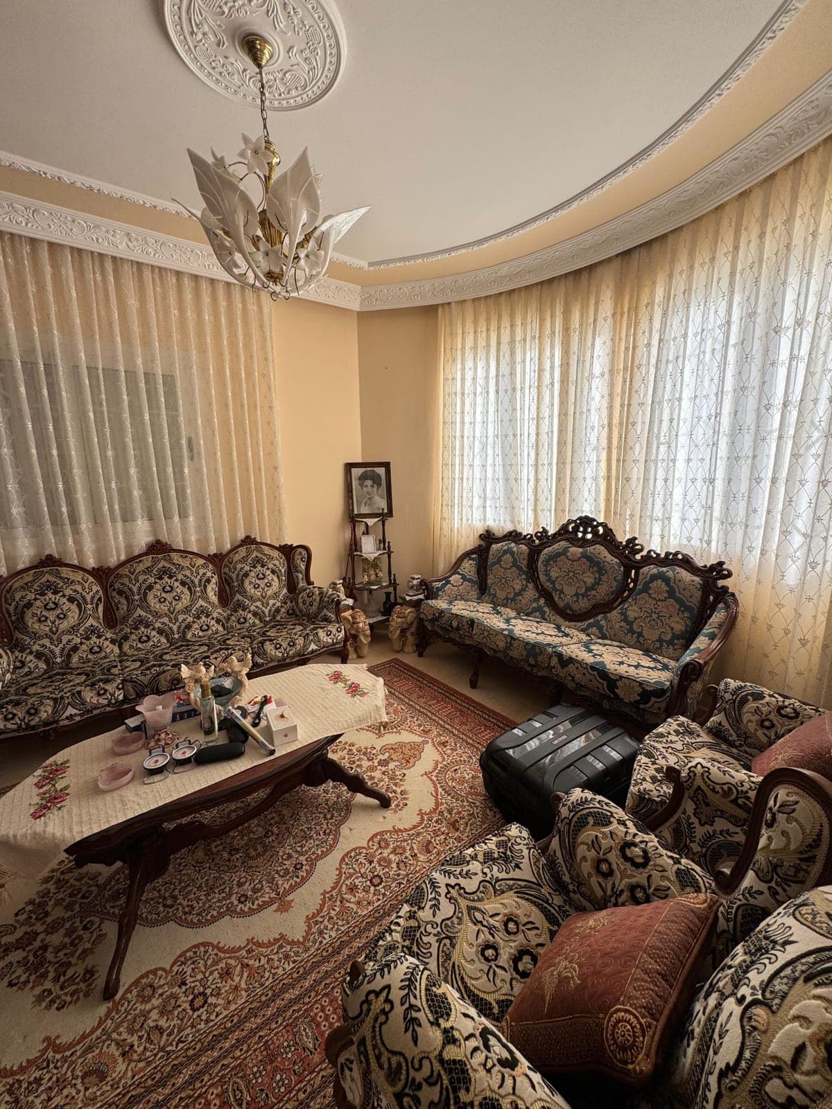 Spacious living room with patterned sofa set and coffee table