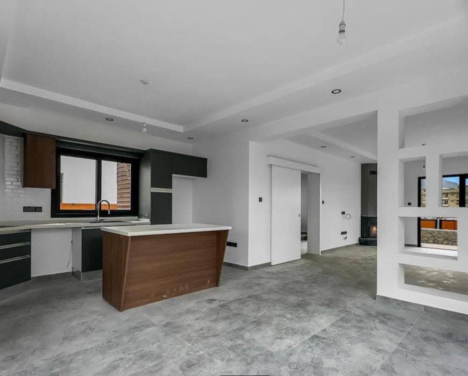 Built-in kitchen counter and island, spacious living area with fireplace