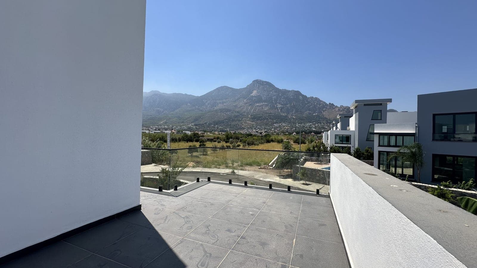 Mountain and valley view from a spacious terrace area