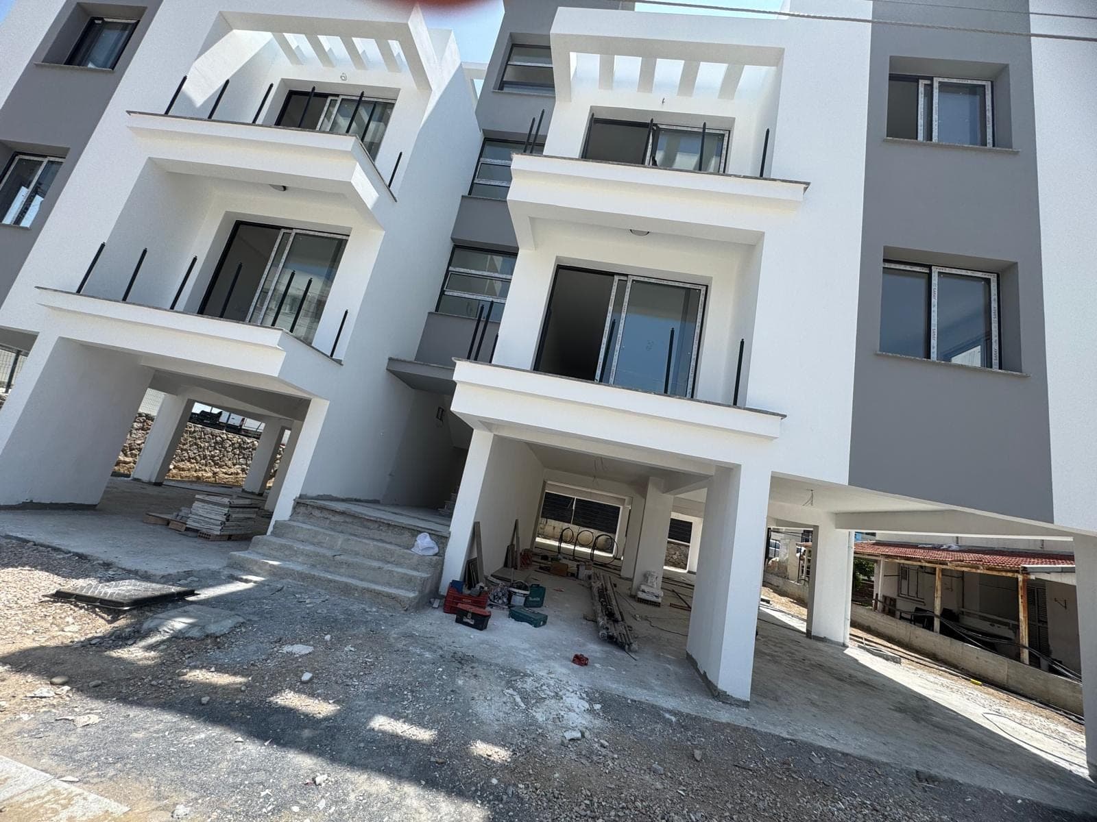 Side facade of the new building and ground floor parking area