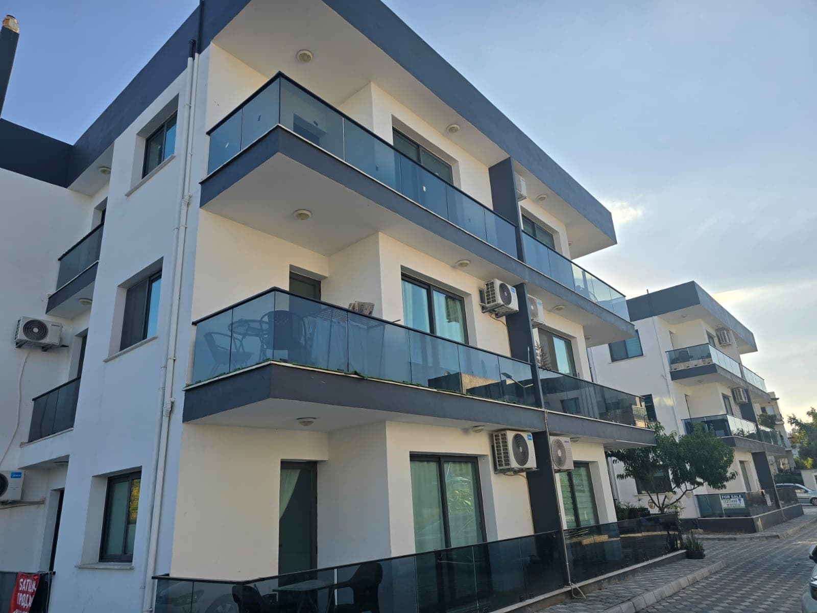 Exterior of a modern apartment building with glass balconies