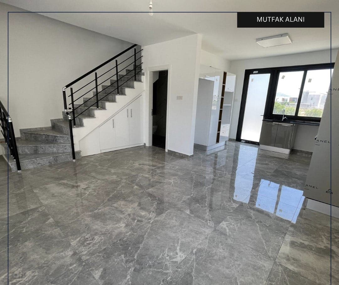Kitchen area and stairs leading to the upper floor