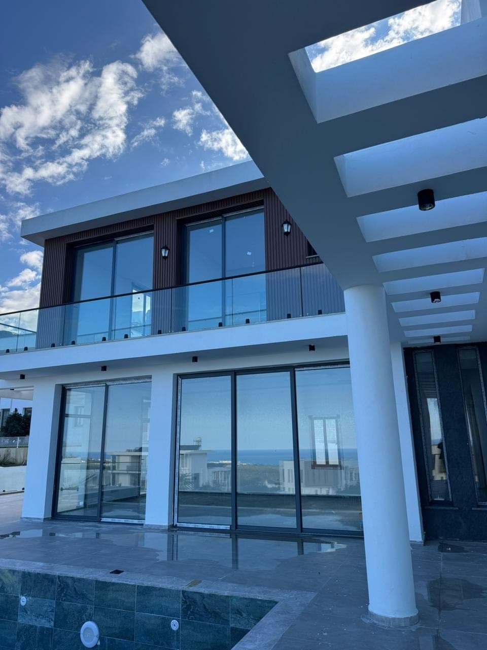 Modern villa exterior with pool and sea view