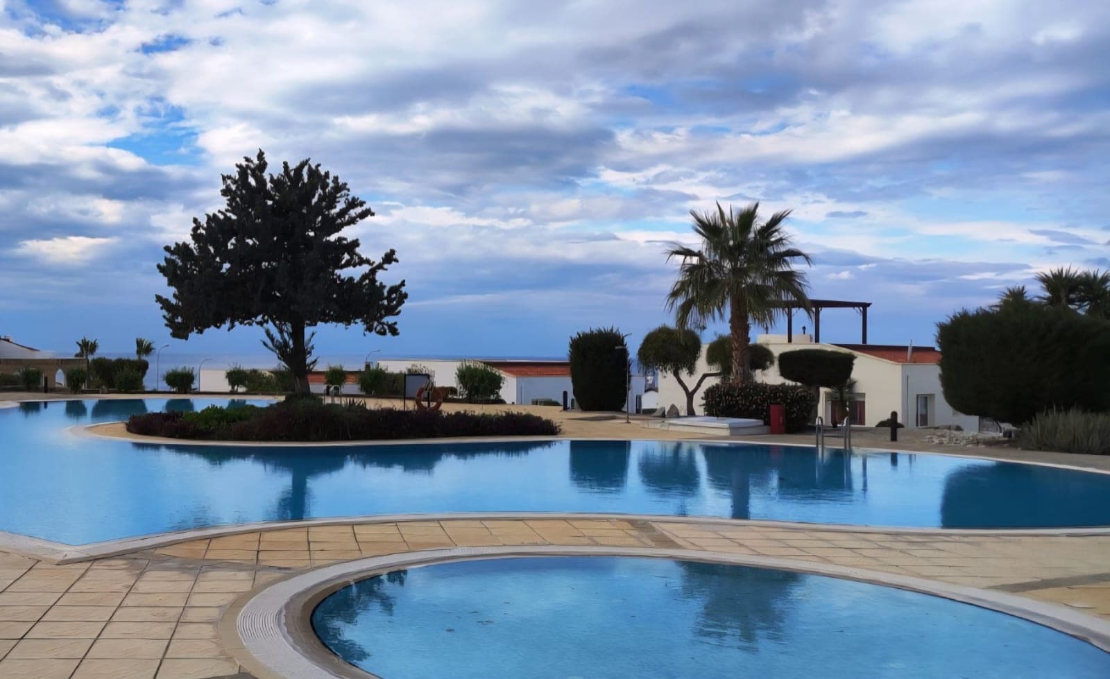 Spacious shared pool area with sea view