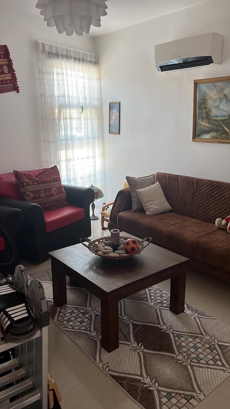 Living room with sofa set and air conditioning unit