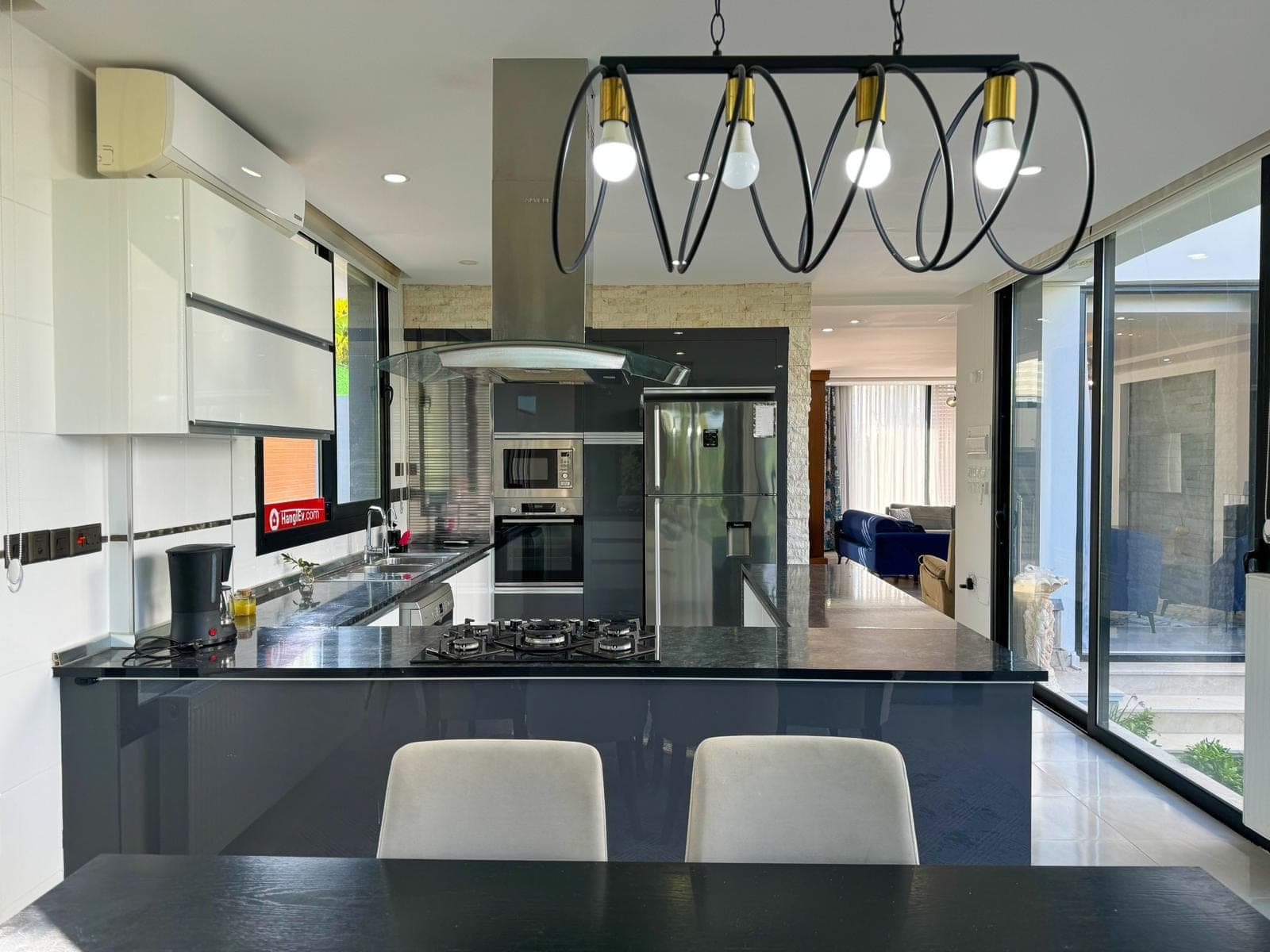 Modern kitchen with built-in appliances and island counter