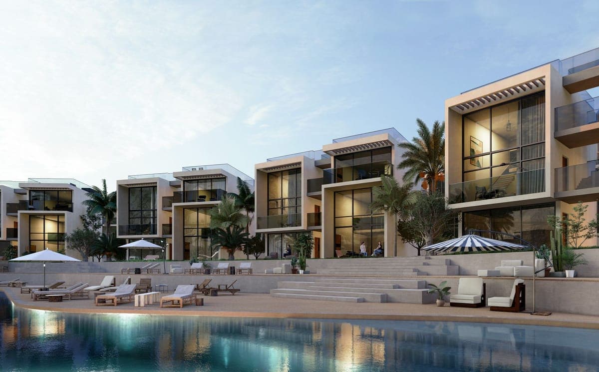 Modern architectural residences with communal pool and sunbathing areas.