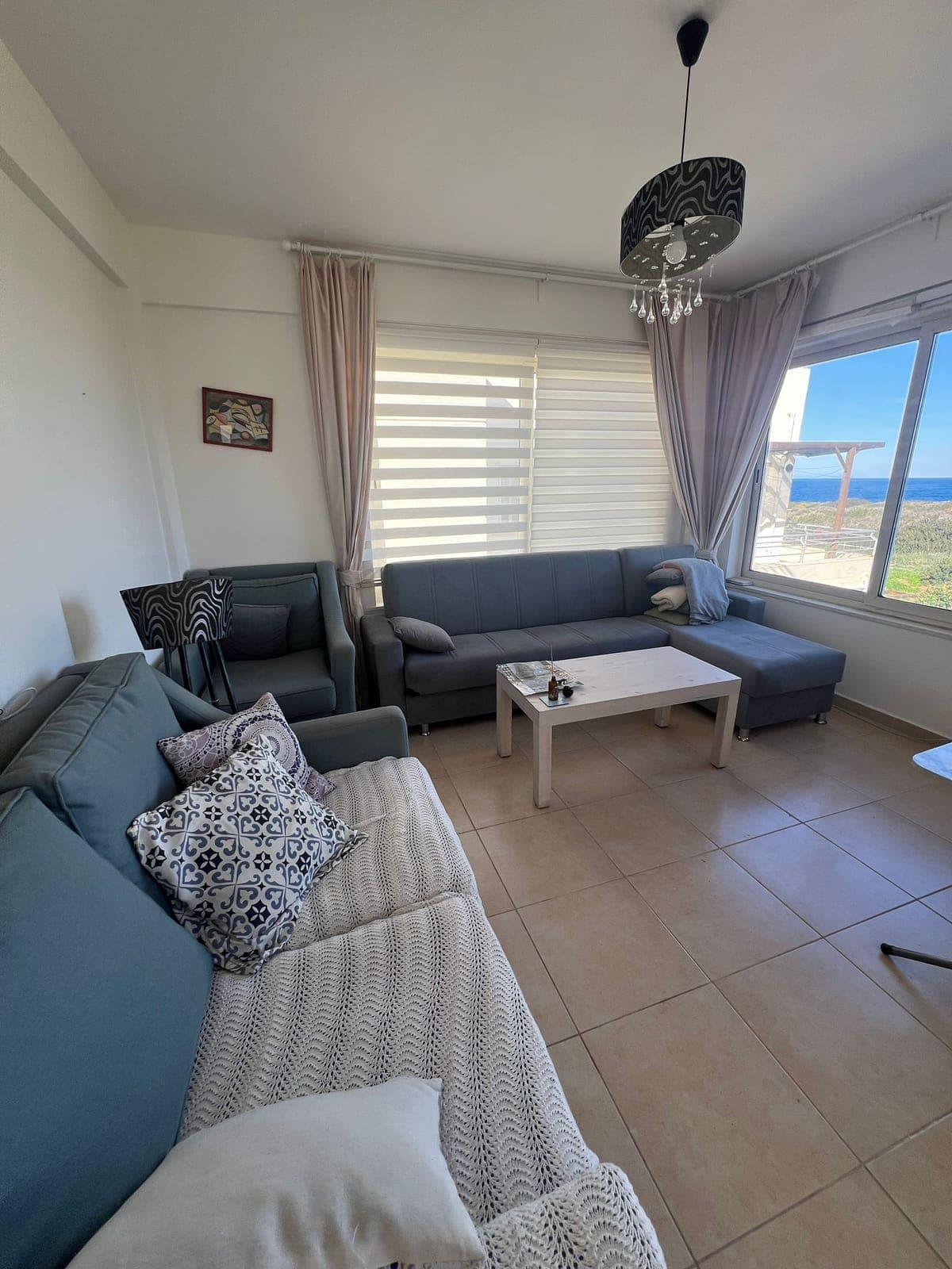 Living room with sea view and spacious seating area.