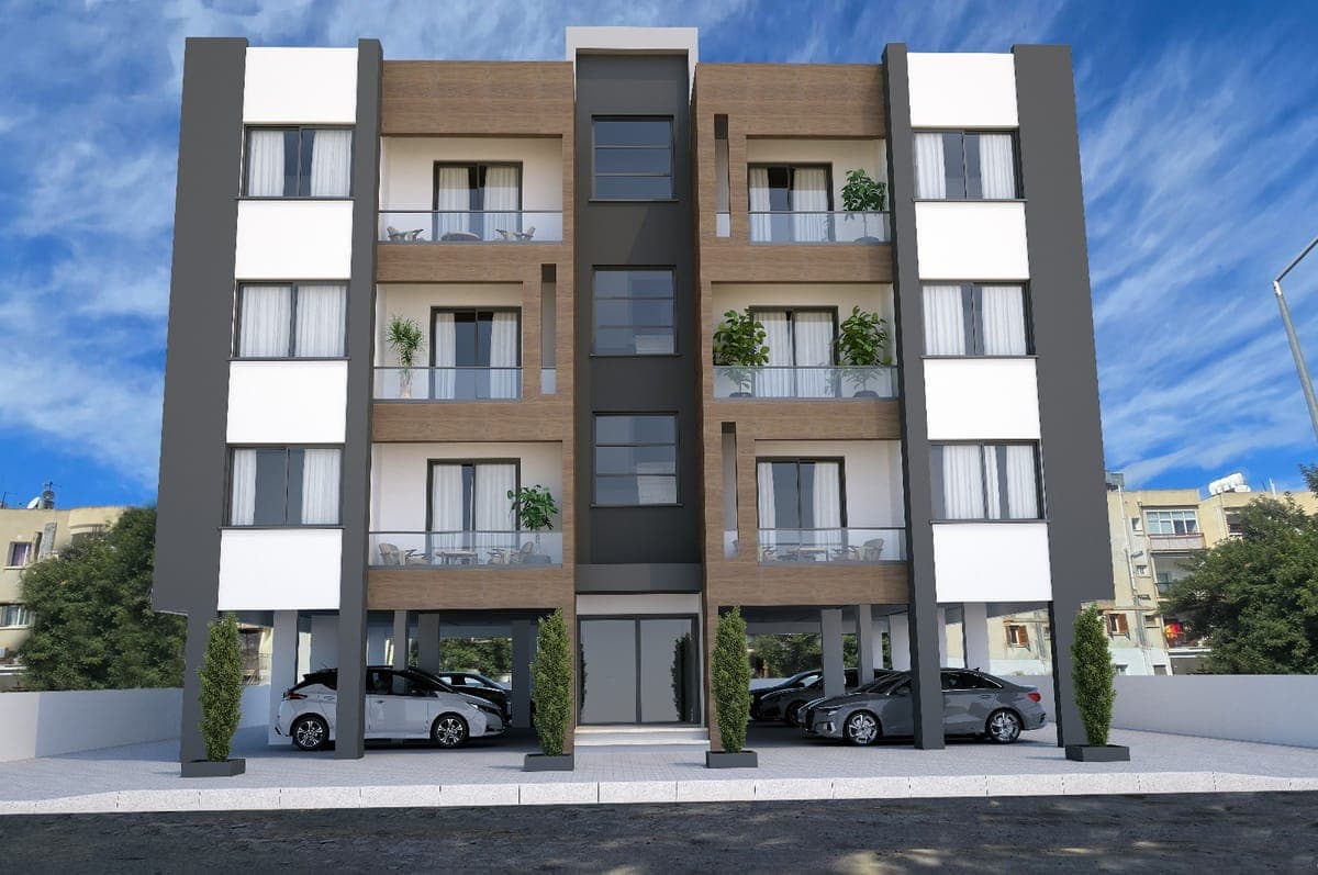 Front facade of a modern apartment building with ground floor parking.