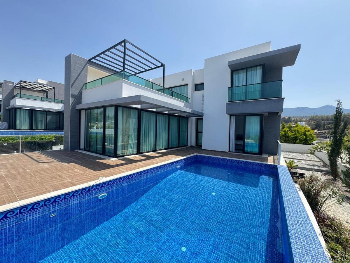 Exterior of a modern detached house with a pool.