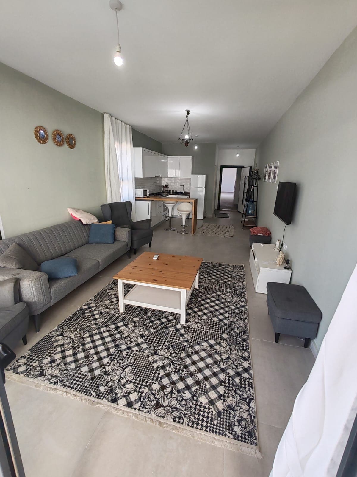 Spacious living room with open-plan kitchen and seating area.
