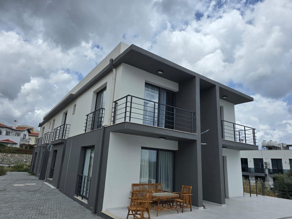 Exterior of a modern two-story detached house with garden area.