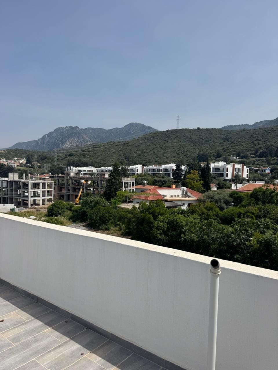 Spacious balcony or terrace with mountain and city view.
