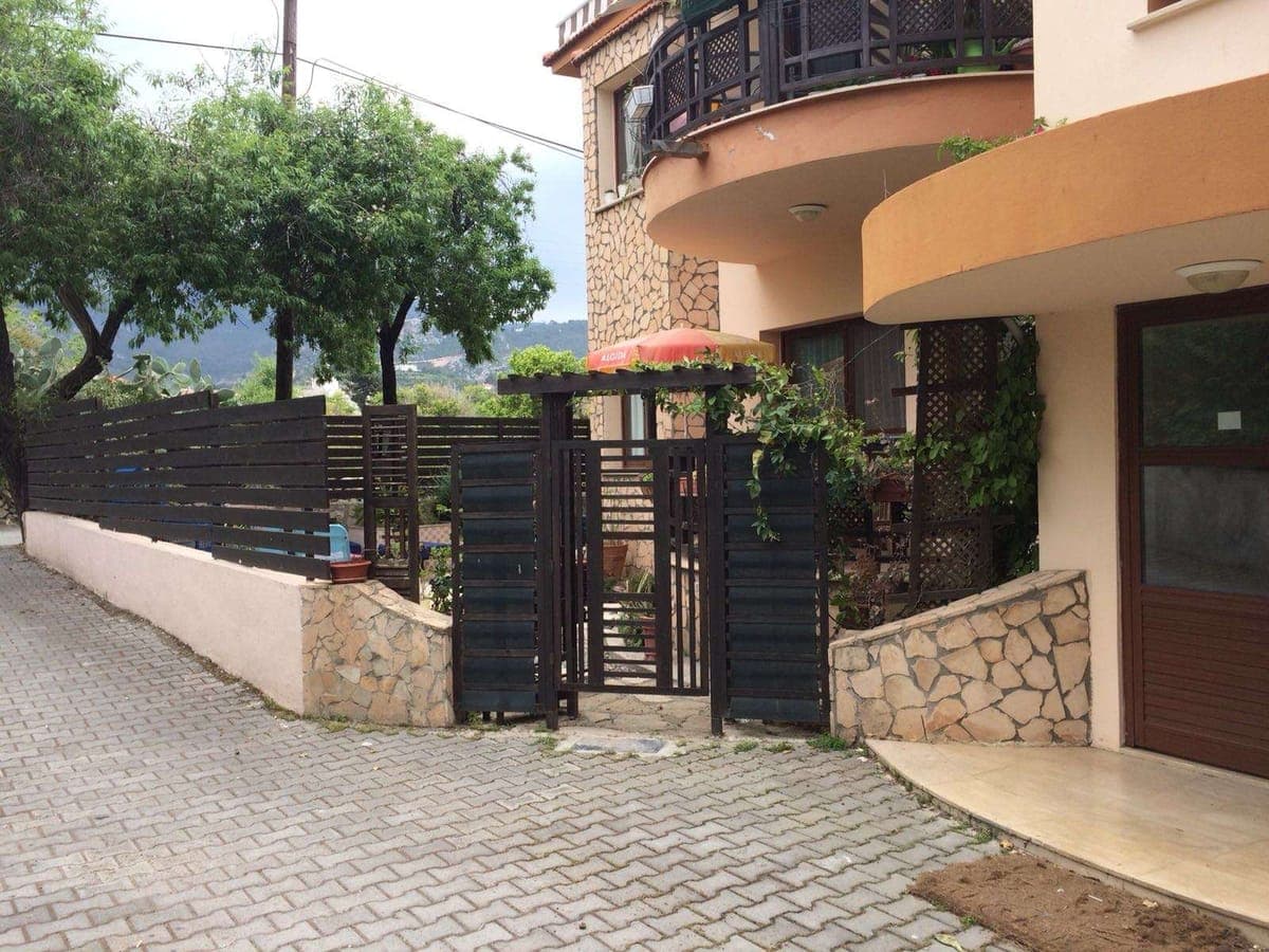 Exterior of a detached house with stone details and garden entrance.