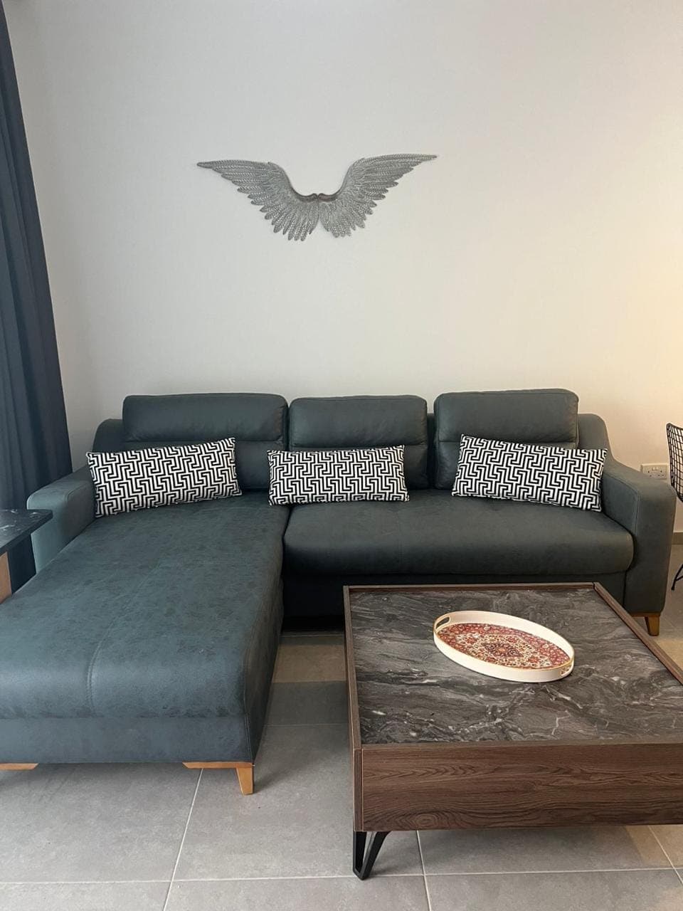 Living area furnished with a modern L-shaped sofa and coffee table.