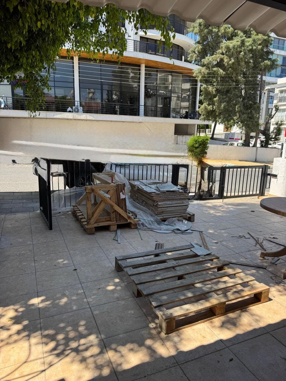 Street level view of surrounding buildings and construction materials.