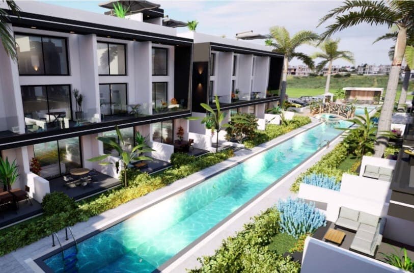Exterior view of a modern residential project with pool and landscaping.