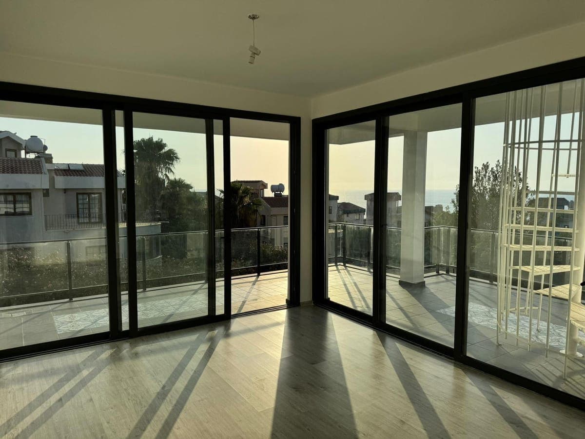 Spacious living room, sliding glass doors to sea view balcony.